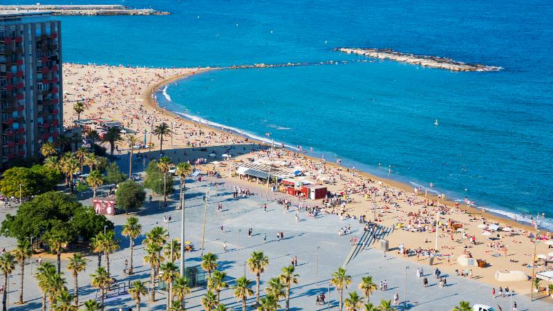 View-of-the-beach-in-Barcelona-with-crowds-of-people-on-the-sand