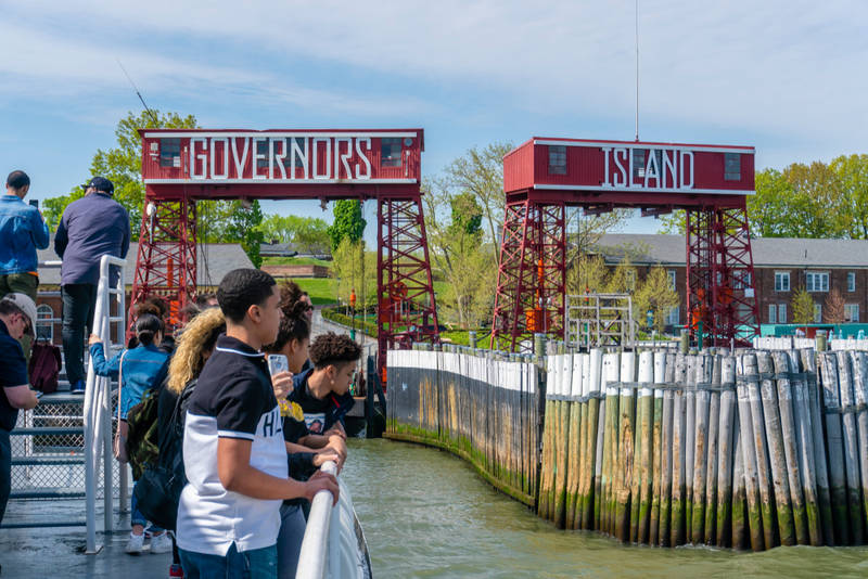 Children looking across a river as part of Open House fall events in New York