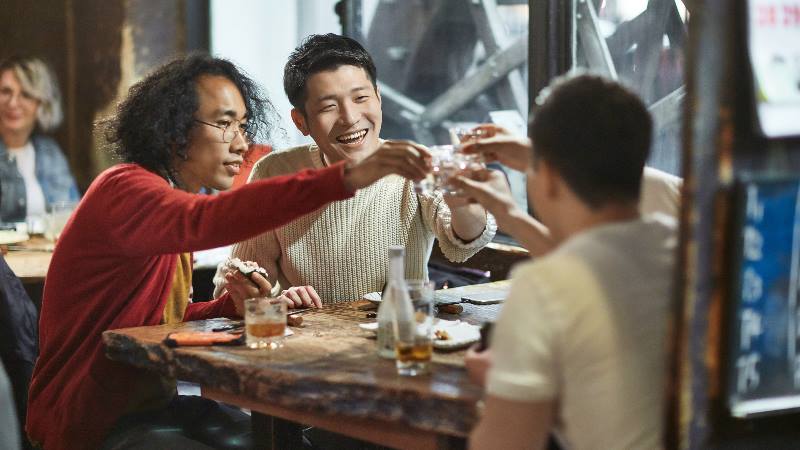 Group of men drinking sake An activity to try before the Rugby World Cup Final