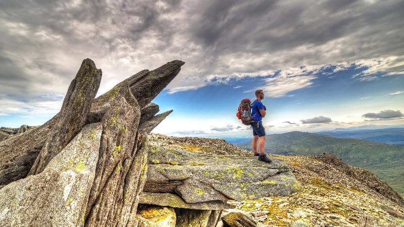 Wales - man standing on mountain in Snowdonia