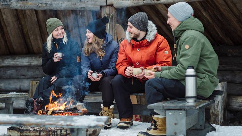 Group-of-people-sitting-around-keeping-warm-in-a-Nordic-winter