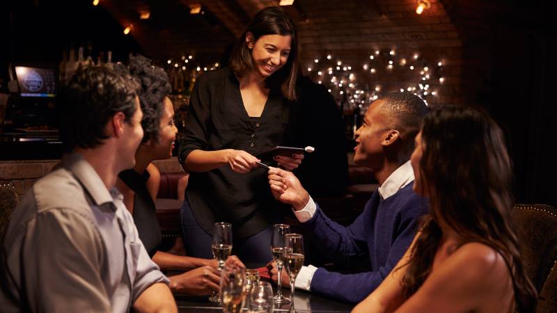 Group-of-people-paying-the-restaurant-bill-travel-apps-2020