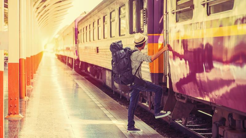 Man-climbing-aboard-a-train-Sustainable-travel-train