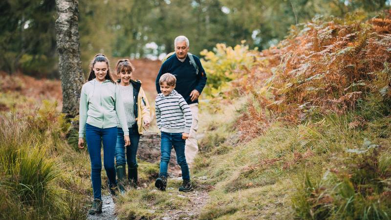 Two-children-are-hiking-with-their-grandparents-in-the-woodland-of-the-Lake-District