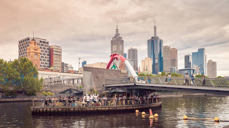 ponyfish-island-cafe-and-south-bank-pedestrian-bridge-with-people-in-the-evening