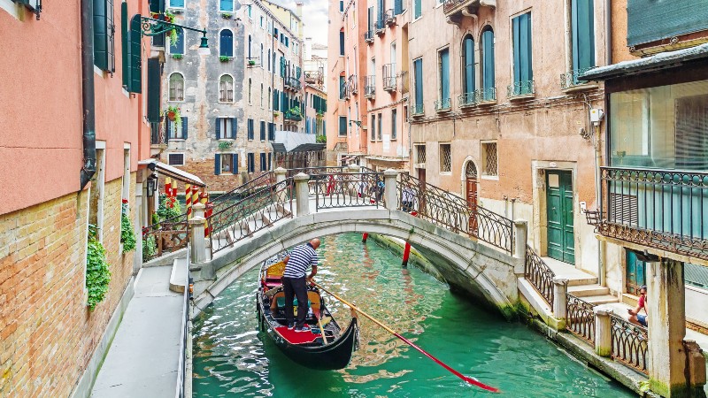 Gondola moving along a canal in Venice